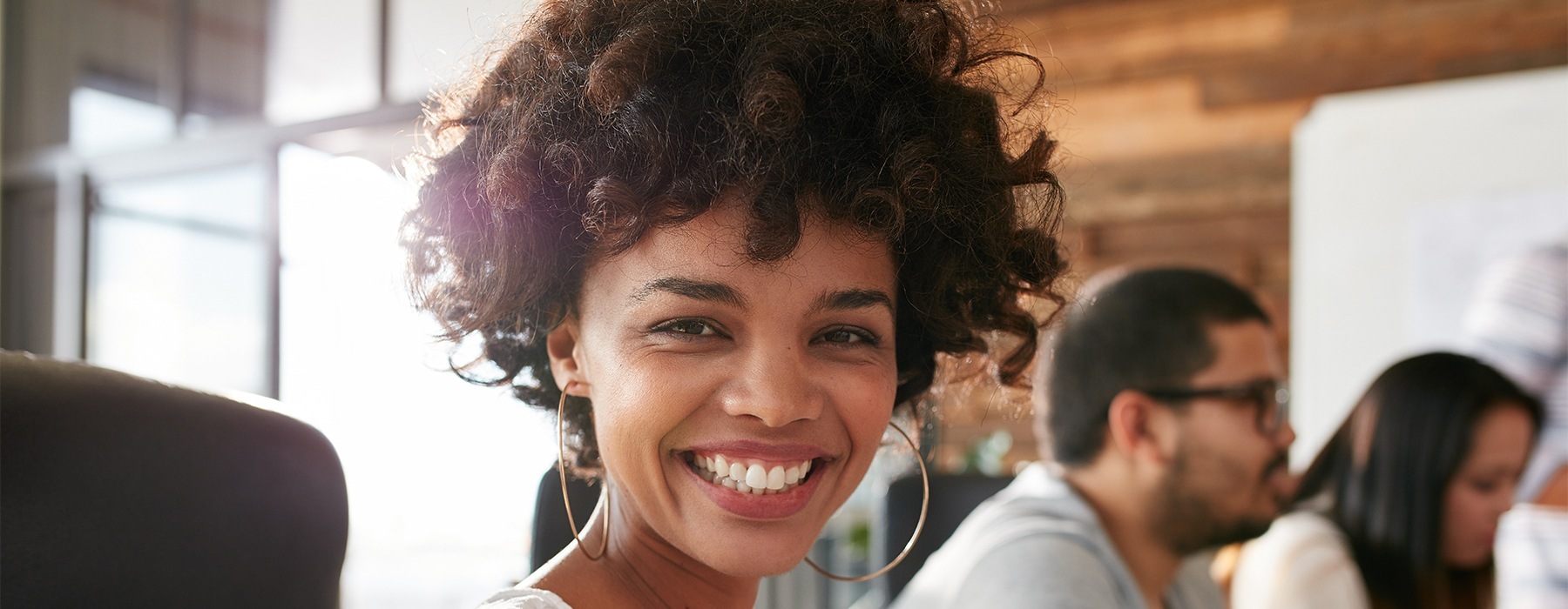 a woman smiling into a camera