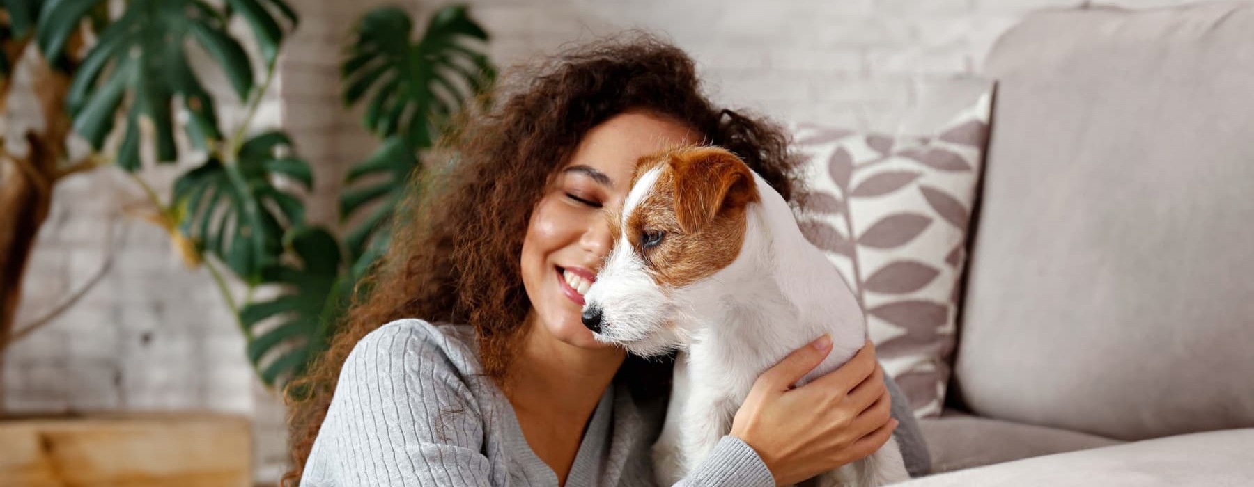 a woman embracing with her puppy in a living room